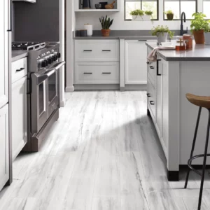 Gray luxury vinyl waterproof flooring in kitchen | Petersen's Carpet & Flooring